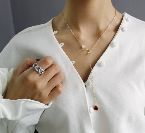 Gold-tone chain necklace with red heart pendant and pearl