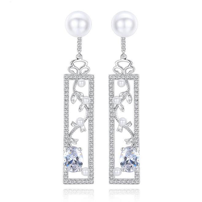 Long pearl-style drop earrings with decorated bar