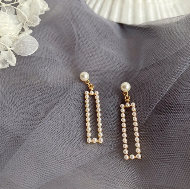 Gold-tone pearl-style earrings in a retro design