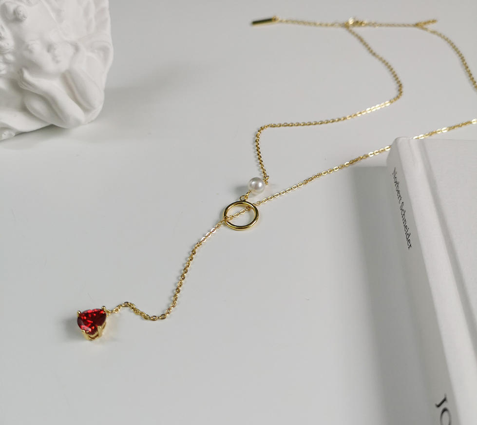 Gold-tone chain necklace with red heart pendant and pearl
