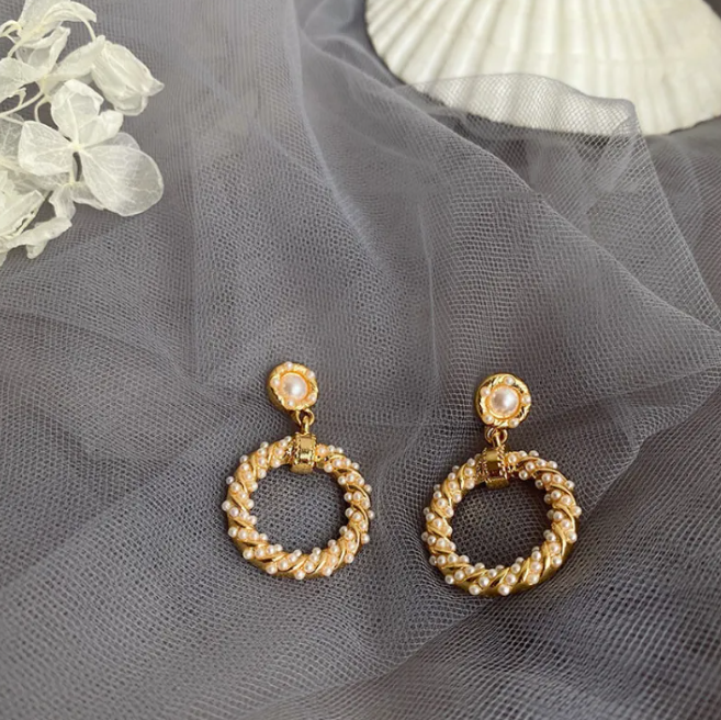 Gold-tone pearl-style earrings in a retro design