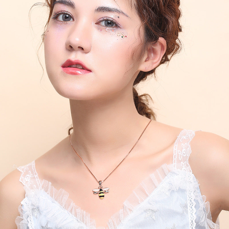 Rose gold-tone necklace with small bee pendant