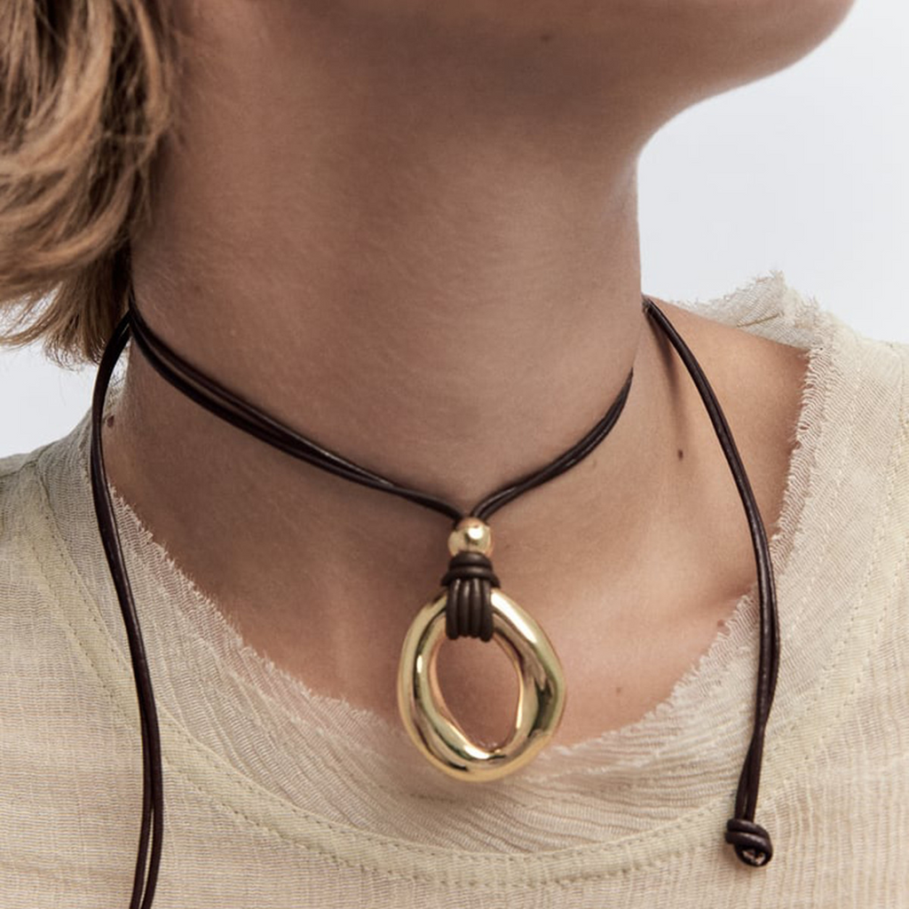 Irregular circle pendant on dark cord necklace