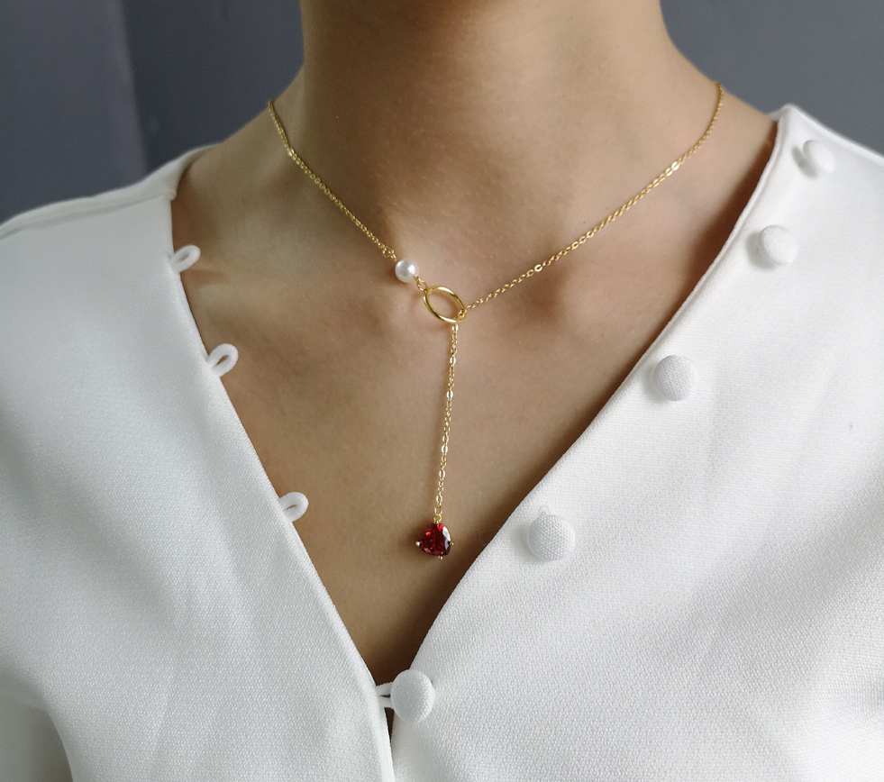 Gold-tone chain necklace with red heart pendant and pearl