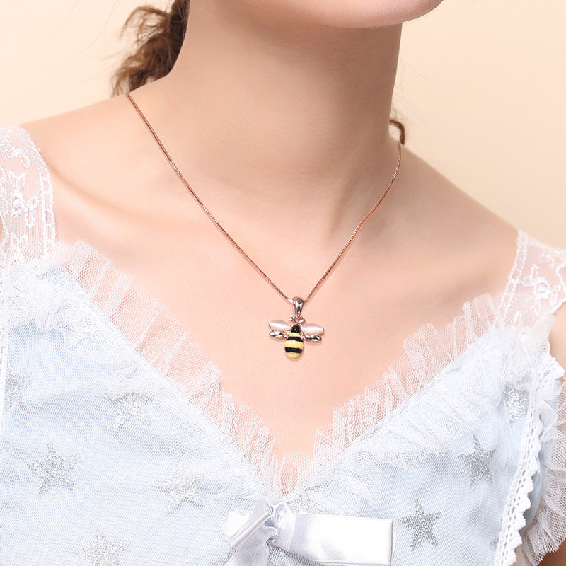 Rose gold-tone necklace with small bee pendant