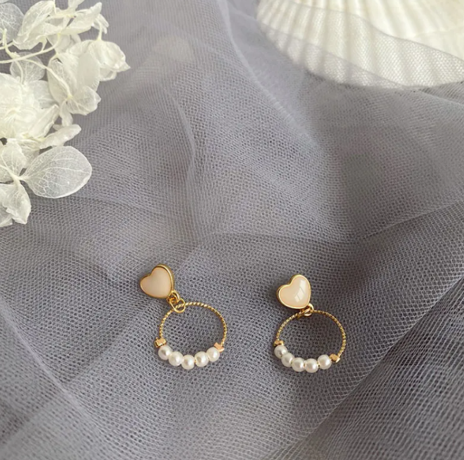Gold-tone pearl-style earrings in a retro design