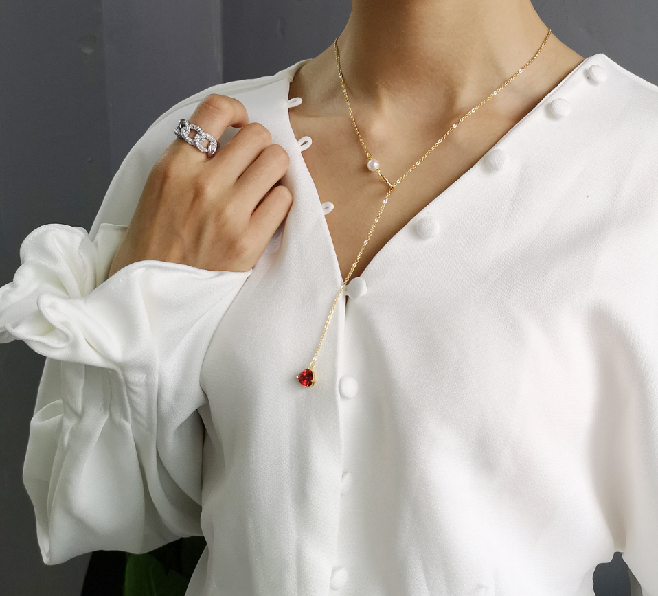 Gold-tone chain necklace with red heart pendant and pearl