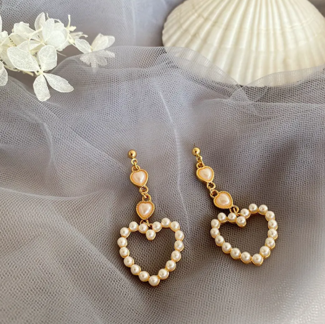 Gold-tone pearl-style earrings in a retro design