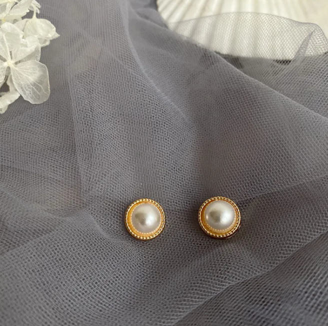 Gold-tone pearl-style earrings in a retro design