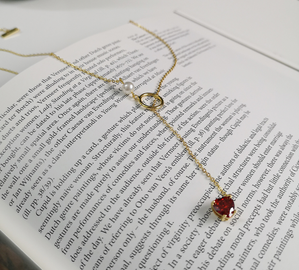Gold-tone chain necklace with red heart pendant and pearl