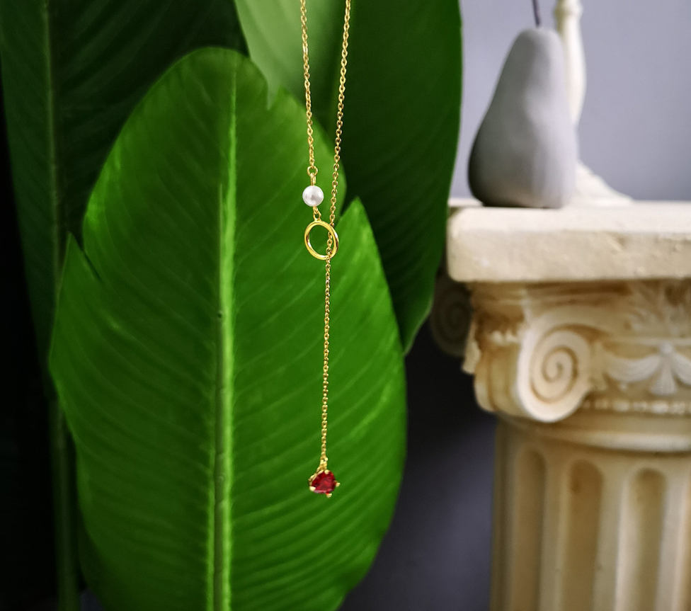 Gold-tone chain necklace with red heart pendant and pearl