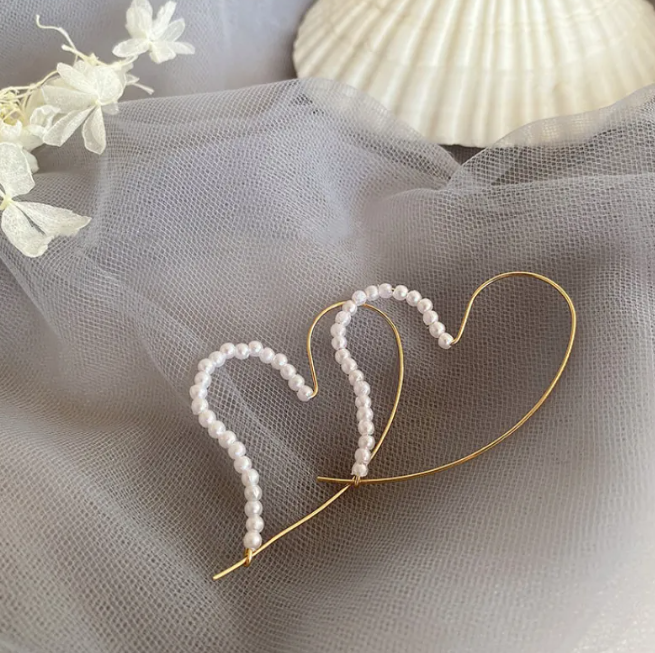 Gold-tone pearl-style earrings in a retro design