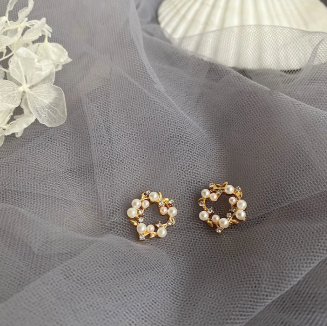 Gold-tone pearl-style earrings in a retro design