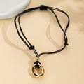 Irregular circle pendant on dark cord necklace