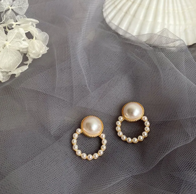 Gold-tone pearl-style earrings in a retro design